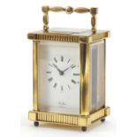 St James brass cased carriage clock with enamelled dial having Roman numerals, 11.5cm high