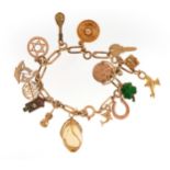 9ct gold charm bracelet with a collection of mostly 9ct gold charms, some enamel, 18cm in length,