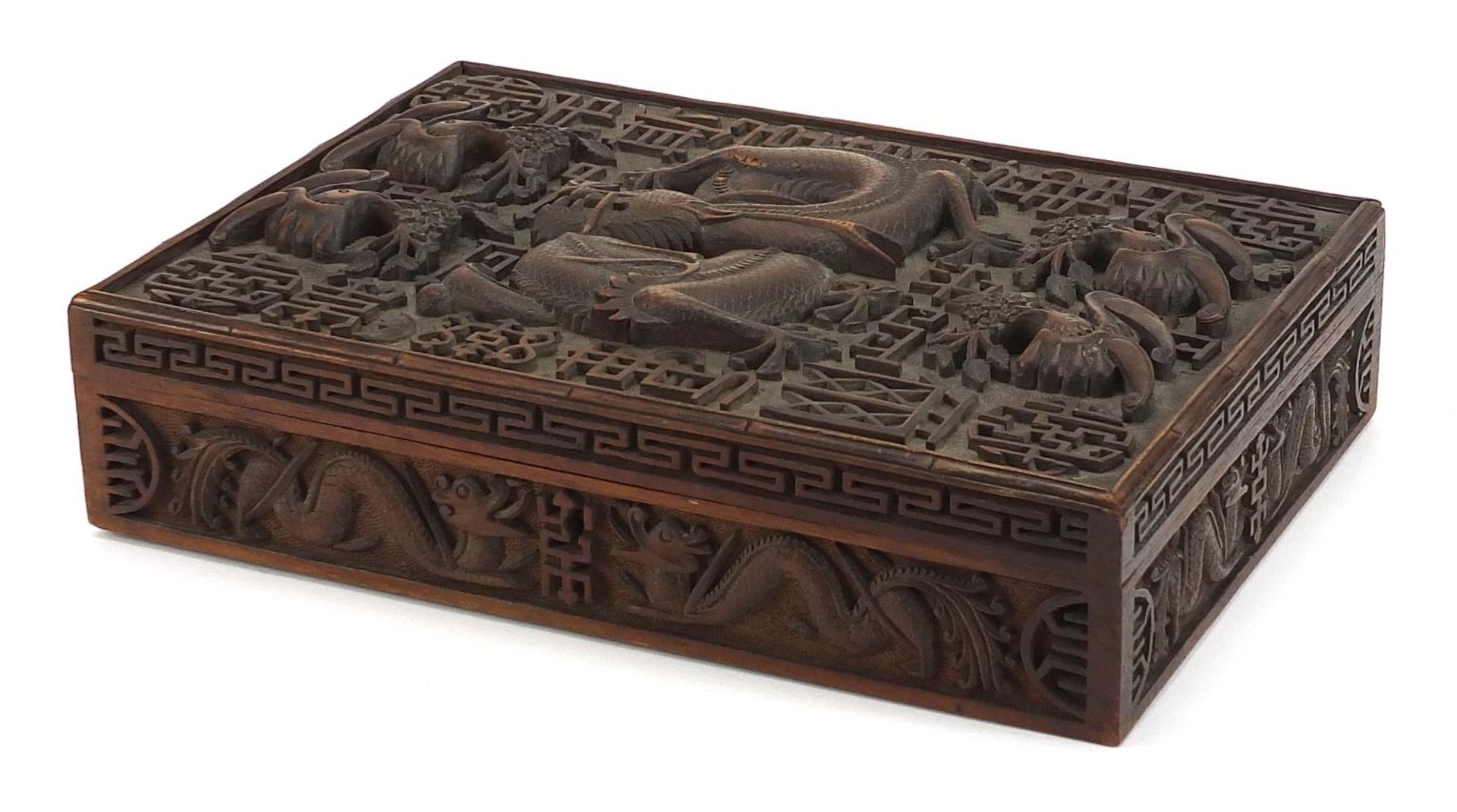 Large Chinese hardwood workbox deeply carved in relief with dragons and bats, 7.5cm H x 30.5cm W x