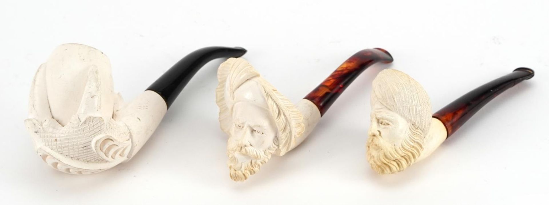 Three Meerschaum style pipes, the largest 16cm in length