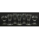 Eight 18th/19th century penny lick illusion glasses, the largest 9.5cm high