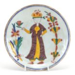 Turkish Kutahya pottery dish hand painted with a figure, 15cm in diameter