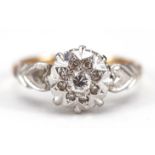 18ct gold and platinum diamond cluster ring with love heart shoulders housed in a tooled leather