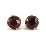 Pair of unmarked gold red stone solitaire stud earrings, 8mm in diameter, 2.1g