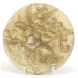 Chinese circular jade disc carved with a dragon and flower, 17cm in diameter