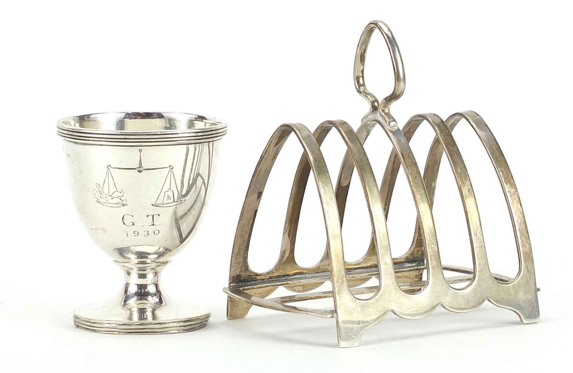 Silver four slice toast rack and silver eggcup, the largest 8.5cm wide, total 122.4g