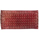 Rectangular Persian Turkmen red ground carpet having an all over geometric design, 345cm x 215cm