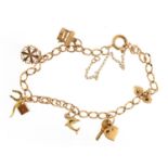 9ct gold charm bracelet with a selection of charms including wishing well, snowflake and