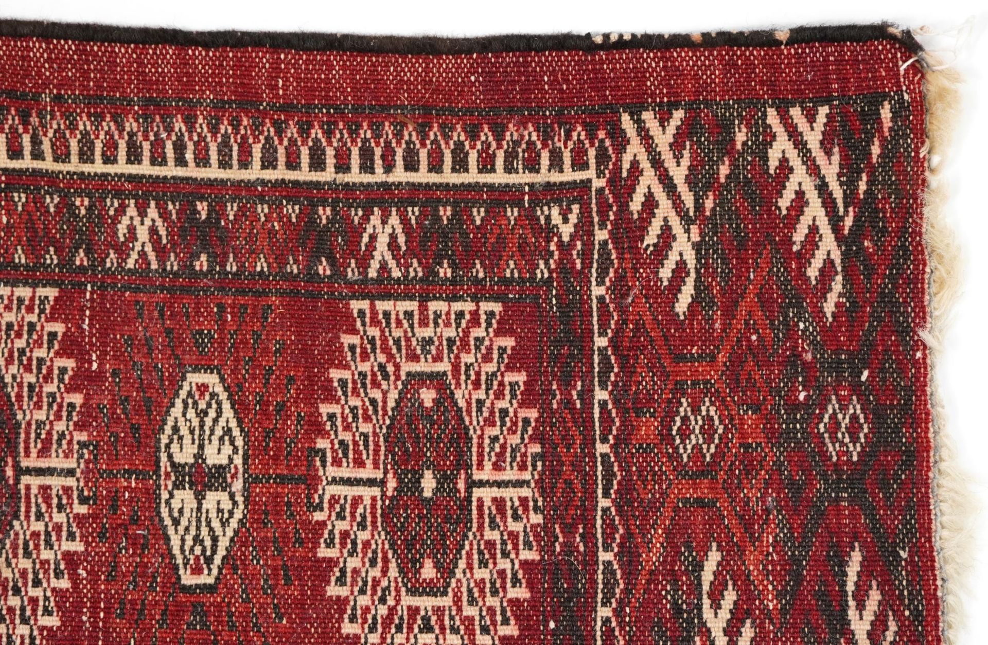 Rectangular Persian Turkmen red ground carpet having an all over geometric design, 345cm x 215cm - Image 8 of 8