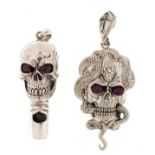 Two sterling silver skull design pendants with ruby eyes including a whistle, the largest 5.5cm