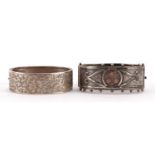 Two silver hinged bangles including a Victorian aesthetic example, the largest 6.5cm wide, 43.4g