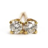 Pair of unmarked 18ct gold diamond solitaire stud earrings, 4.6mm in diameter, 1.0g