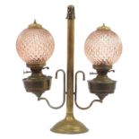 Victorian brass twin oil lamp with peach glass shades, 66.5cm high