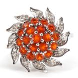 9ct white gold diamond and orange stone flower head ring, size N/O, 3.1g