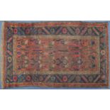 Rectangular Heriz or Caucasian red and blue ground rug having an all over geometric design, 190cm