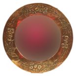 Manner of Liberty & Co, Arts & Crafts circular copper wall mirror with bevelled plate embossed