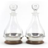 Pair of cut glass decanters with silver mounted oak stands by Simon J Beer London 1986, 27cm high
