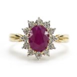 9ct gold oval ruby and diamond cluster ring, the ruby approximately 1.72 carat, total diamond weight