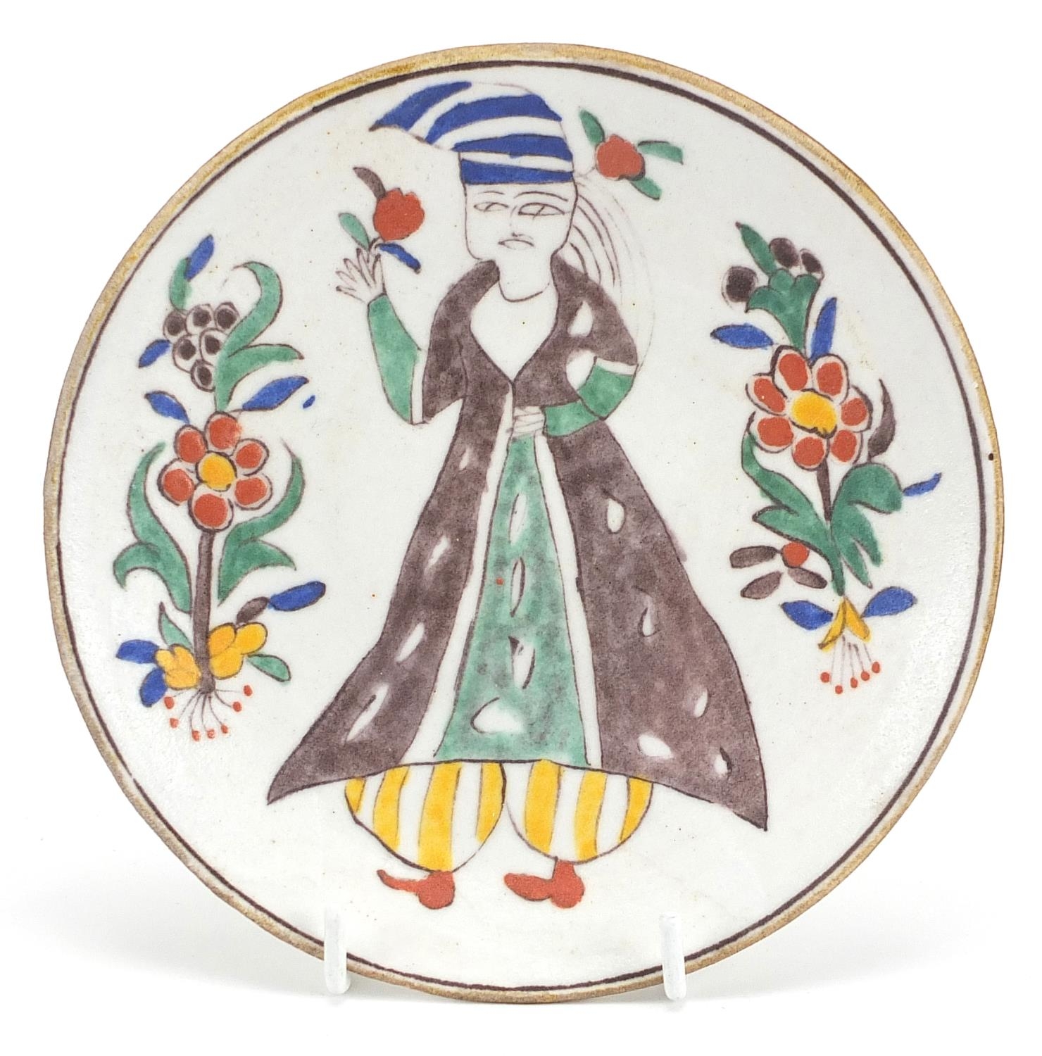 Turkish Kutahya pottery dish hand painted with a figure, 14.5cm in diameter
