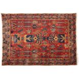 Rectangular Persian Syrian blue and red ground rug having an all over geometric design with flowers,