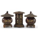 Pair of cast iron and glass garden tealight lanterns decorated with dragonflies and one other, the