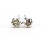 Pair of platinum diamond solitaire stud earrings, approximately 0.20 carat in total