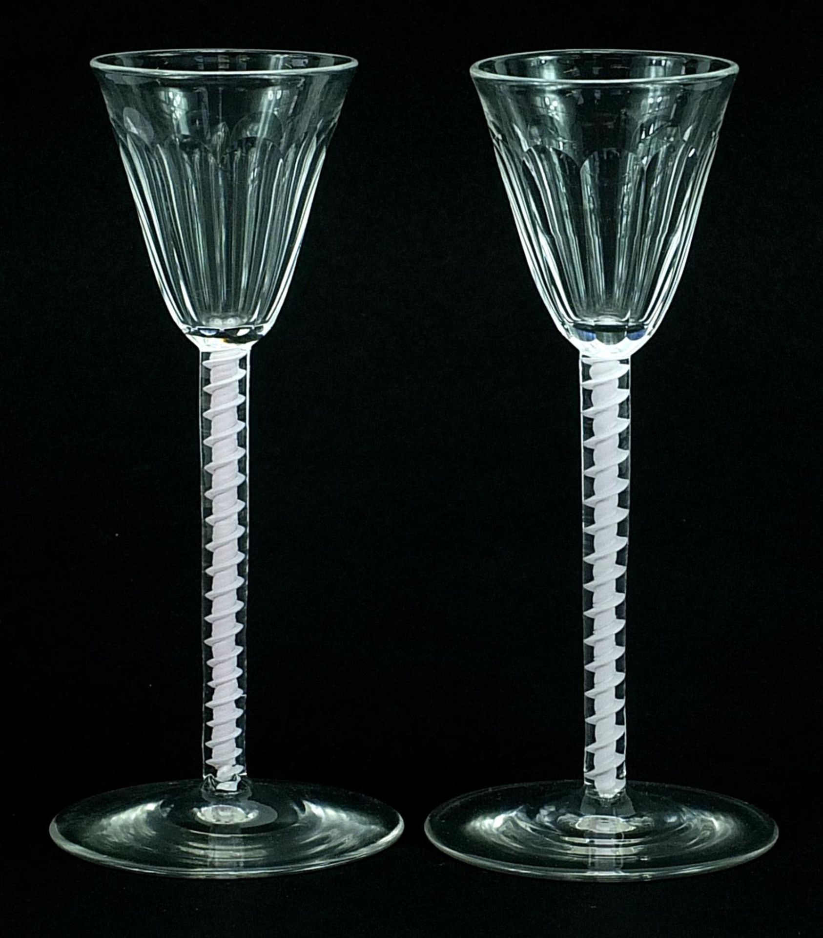 Pair of antique wine glasses with opaque twist stems and facetted bowls, each 14.5cm high