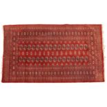 Rectangular Bokhara red ground rug having an all over geometric design, 185cm x 122cm