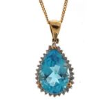 9ct gold diamond and blue topaz tear drop pendant on a 9ct gold necklace, 2.1cm high and 44cm in