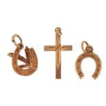 Two 9ct gold horseshoe charms and a 9ct gold cross charm, the largest 2.2cm high, 1.9g