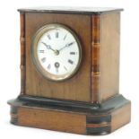 Walnut cased striking mantle clock with enamelled dial, 20cm high