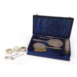 Silver objects comprising four piece dressing table set with fitted case, three napkin rings and two