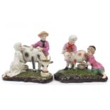 Pair of continental porcelain figure groups of a young farmer boy and girl milking a goat and cow,