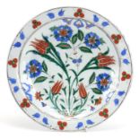 Turkish Iznik pottery shallow dish hand painted with flowers, 31.5cm in diameter