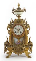 French gilt metal mantle clock with enamelled dial and Sevres style panel hand painted with a