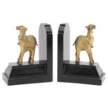 Pair of Indian design ebonised and gilt metal camel bookends, 17cm high