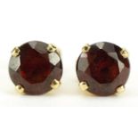 Pair of 9ct gold garnet stud earrings, 7mm in diameter, 1.5g