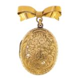 Victorian gilt metal locket engraved with flowers and foliage on a yellow metal bow brooch