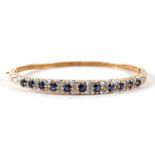 9ct gold sapphire and diamond hinged bangle, the largest sapphire approximately 3.3mm in diameter