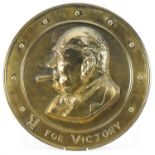 Military interest bronze circular plaque embossed with a portrait of Churchill and motto, 36cm in