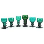 Six 18th/19th century Bohemian style English green glass hock glasses, the largest 14cm high