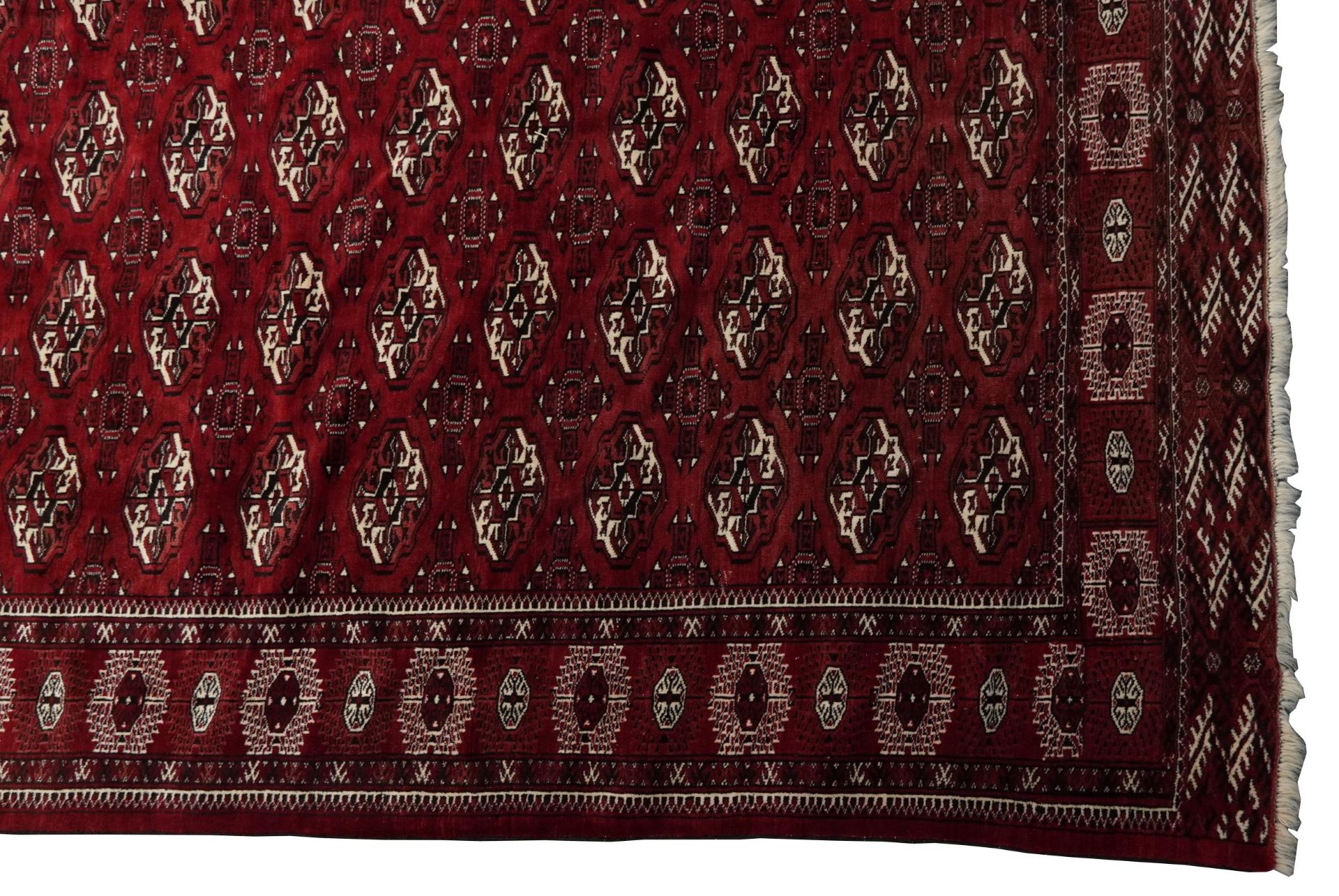 Rectangular Persian Turkmen red ground carpet having an all over geometric design, 345cm x 215cm - Image 7 of 8
