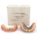 Pair of dentures with a gold cap and white metal plate housed in a Mr Stuart Morgan London box