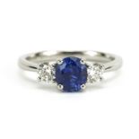Platinum oval sapphire and round brilliant cut diamond three stone ring, the sapphire