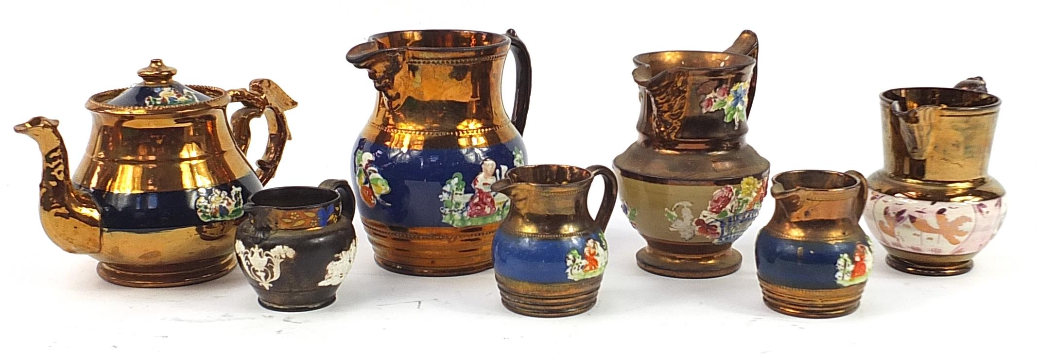 Six Victorian copper lustre pottery jugs and teapot, each decorated in relief with a girl with a cat