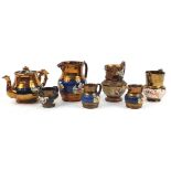 Six Victorian copper lustre pottery jugs and teapot, each decorated in relief with a girl with a cat