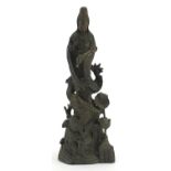 Chinese patinated bronze figure of Guan Yin with a dragon, 36cm high