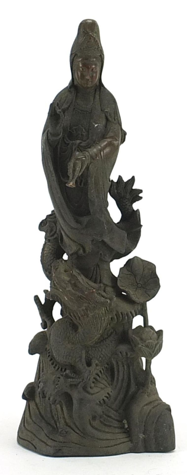 Chinese patinated bronze figure of Guan Yin with a dragon, 36cm high