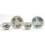 Marianne de Trey, pair of studio pottery cups and saucers hand painted with stylised motifs,