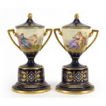 Pair of Royal Vienna porcelain pedestal vases and covers with twin handles, each hand painted with